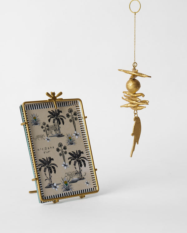 The frame standing and the charm hanging beside it