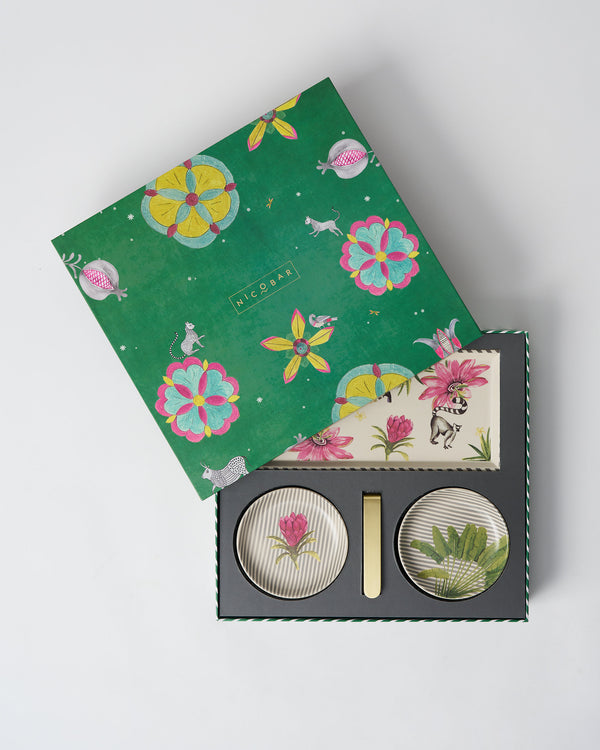 The green gift box, printed with pink and yellow flowers, its lid lifted over the set