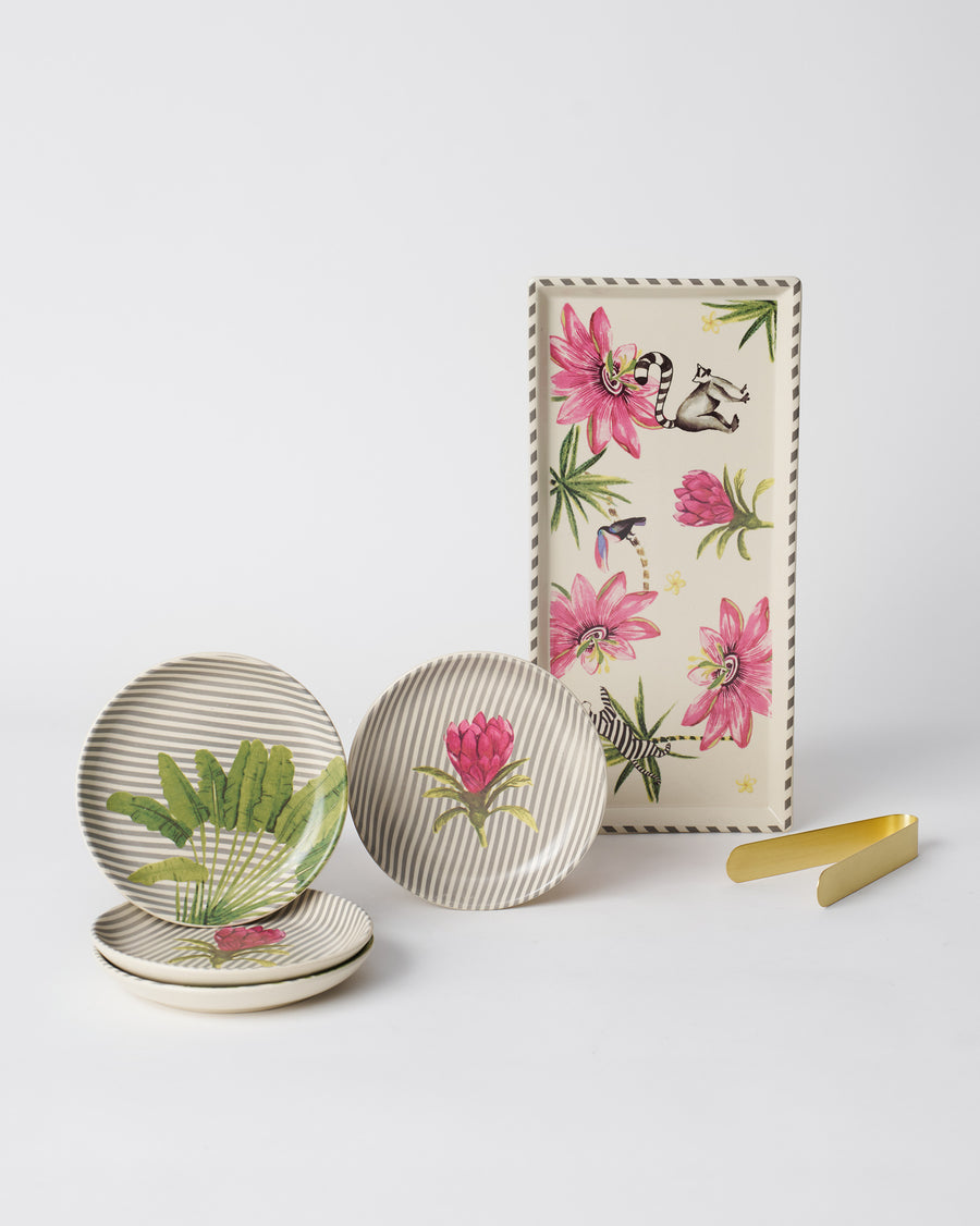 Striped tea plates with pink and green blooms beside the flowered cookie tray and tongs