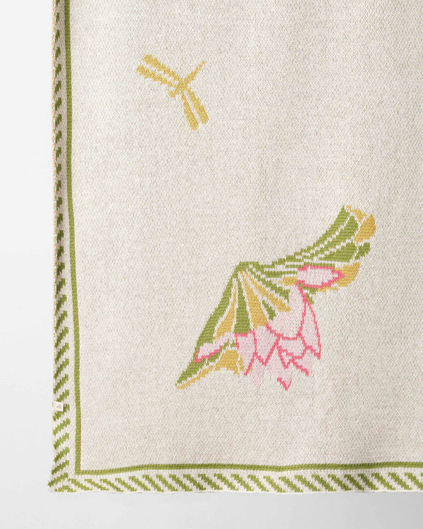 Close view of a lotus and a dragonfly knitted into the throw