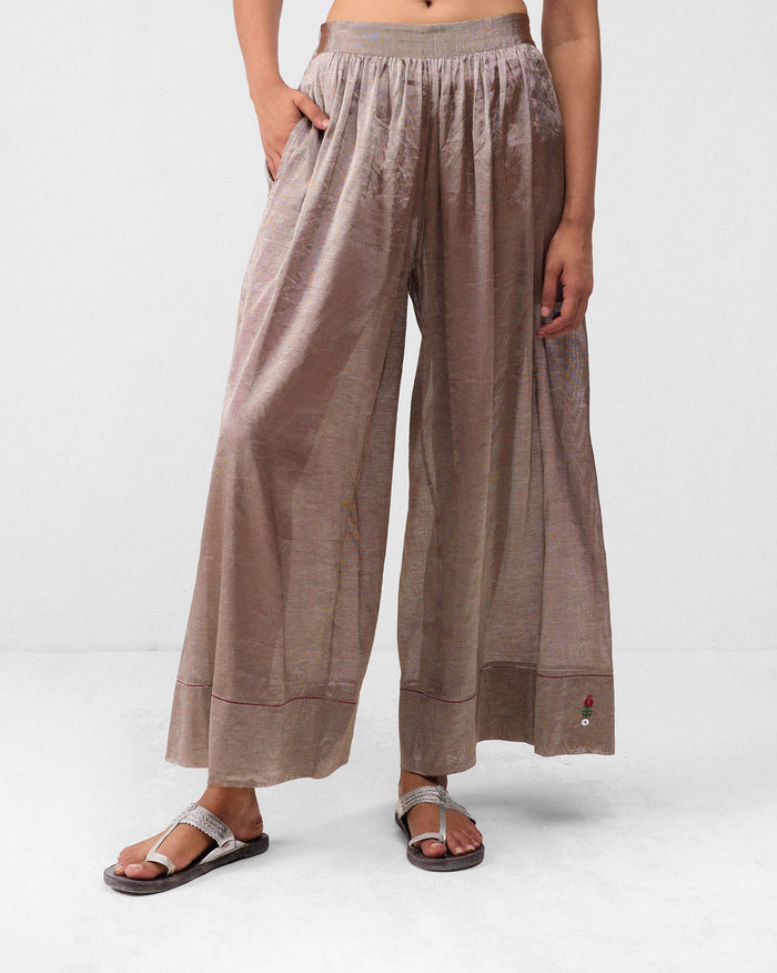 Silver metallic Charisma pants with a wide leg and bordered hem.