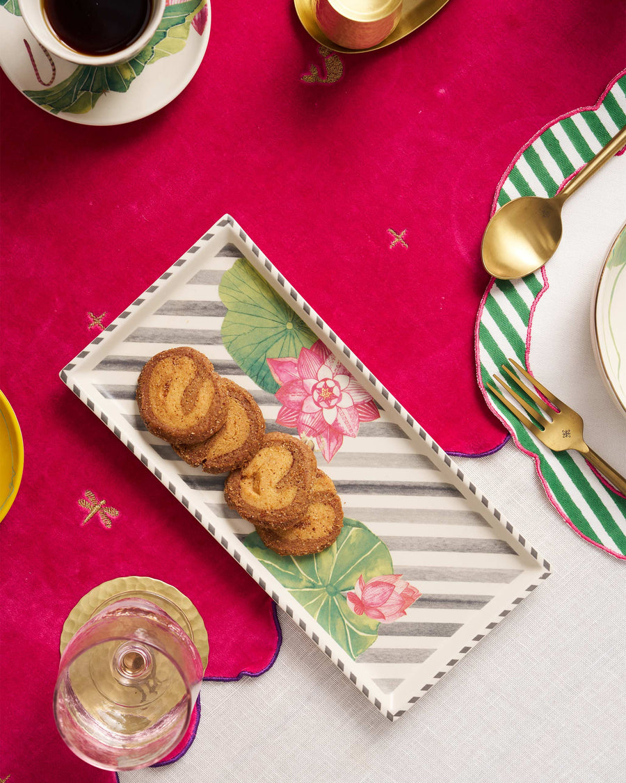 The Lotus Garden tray with spiral cookies on a pink table set for tea