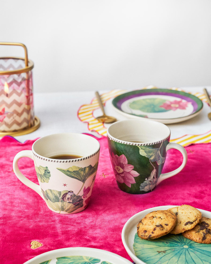 Float conical mugs on a pink cloth beside cookies