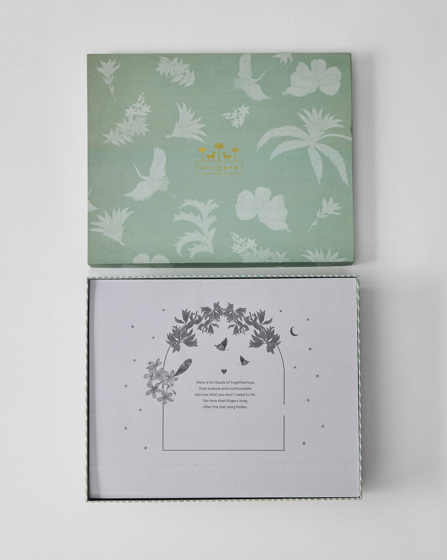 The box open, with a printed keepsake card inside the lid