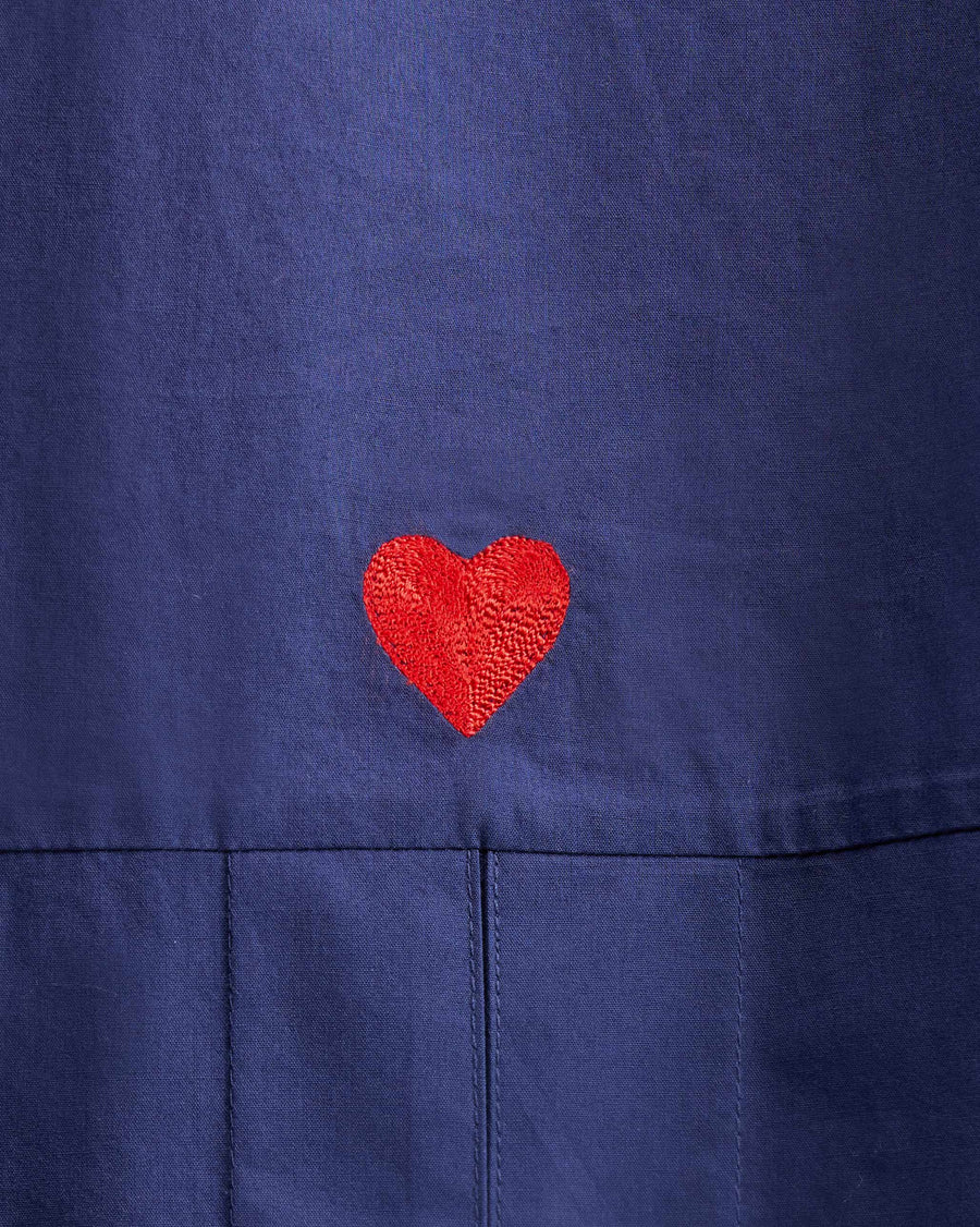A red heart embroidered at the back, just under the yoke.