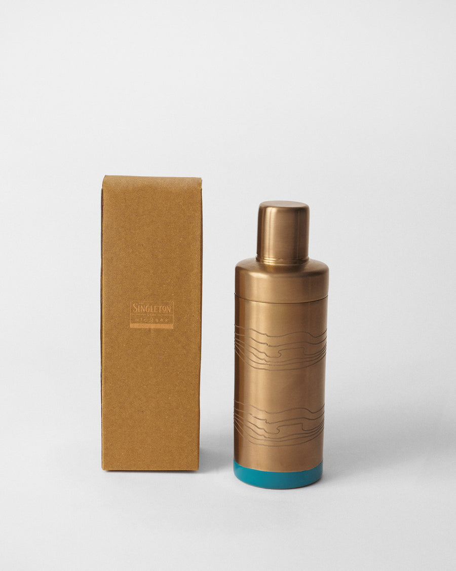 The shaker beside its box.