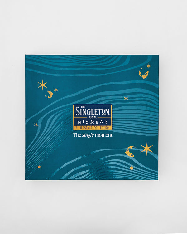 The closed teal box with gold fish and waves
