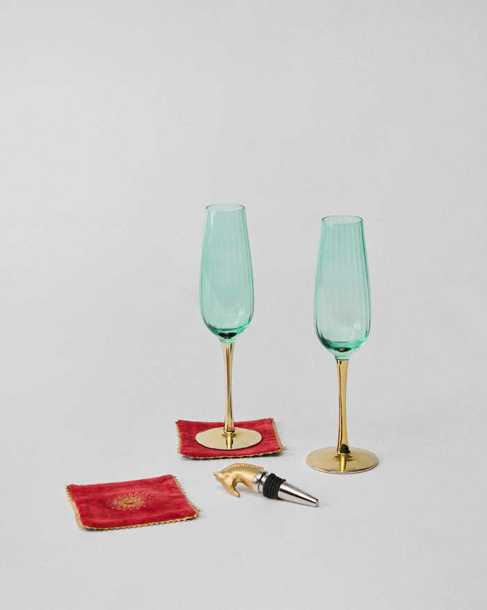 The flutes, coasters and stopper set out