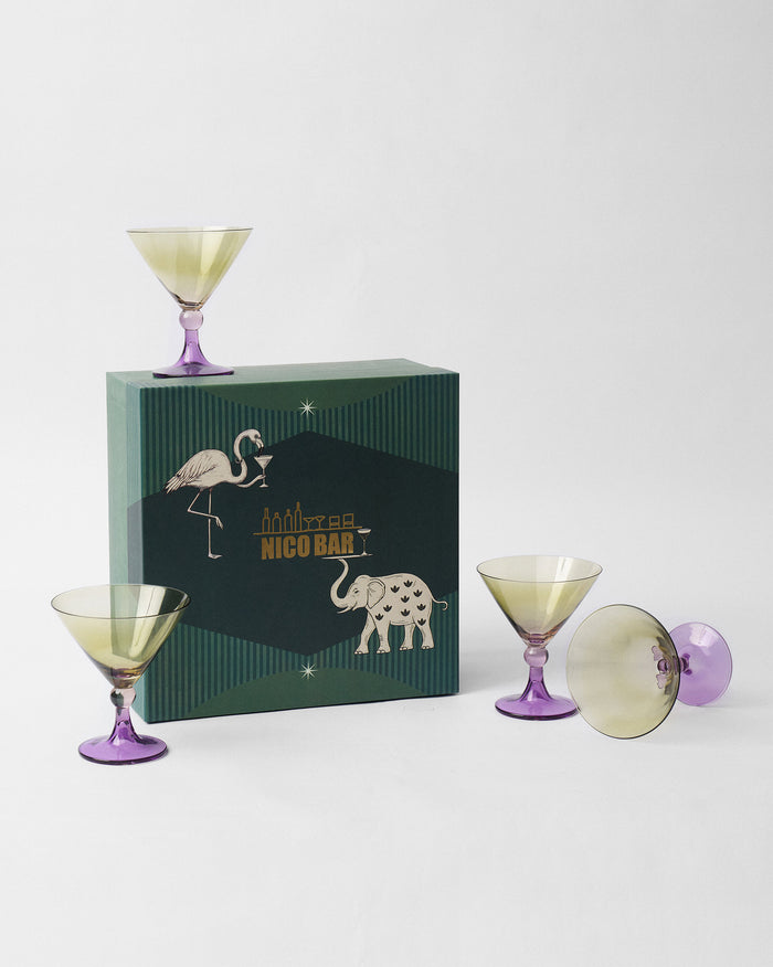 Four Mist cocktail glasses around a green Nicobar gift box.