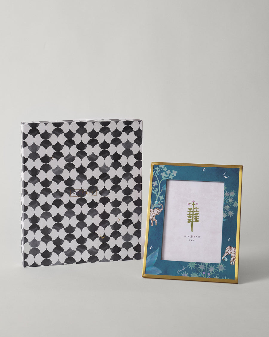 The frame beside its black and white patterned gift box