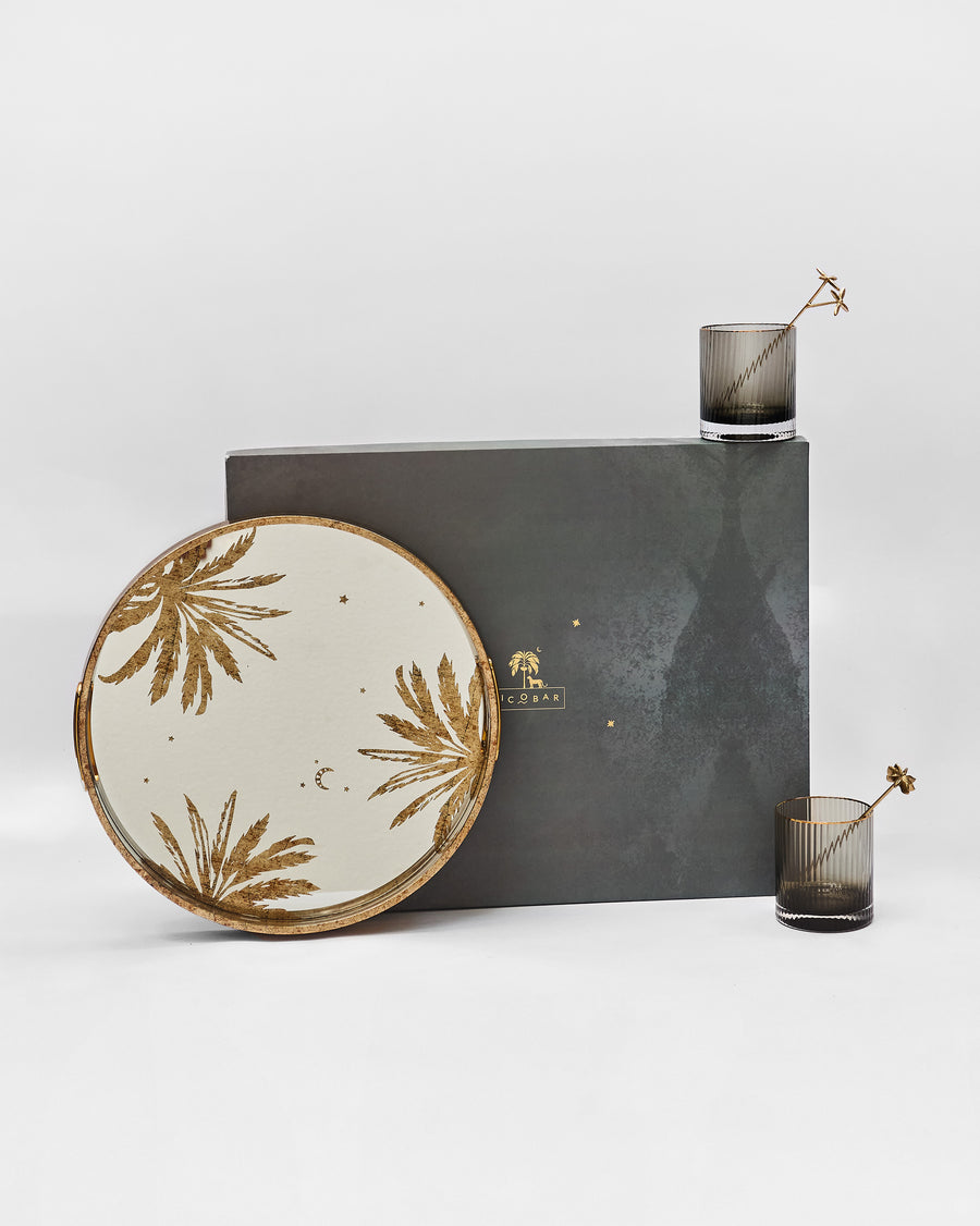 The tray, fluted glasses and stirrers beside the charcoal box
