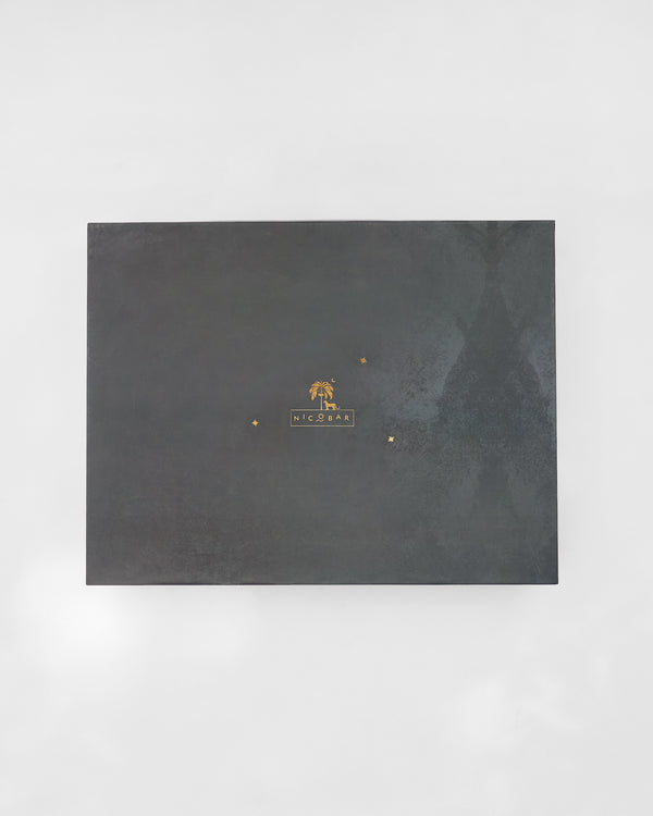 The closed charcoal box with a gold mark