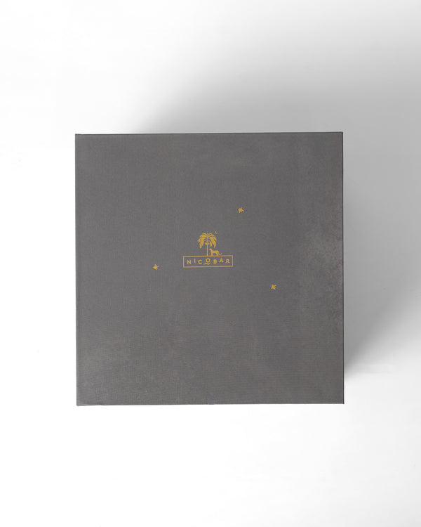 The closed charcoal box with a gold palm mark