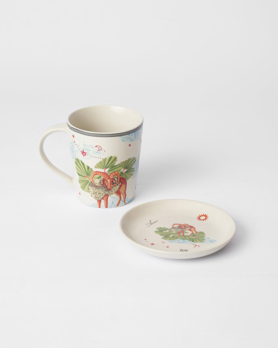 The Aries mug with a ram beside its tea plate