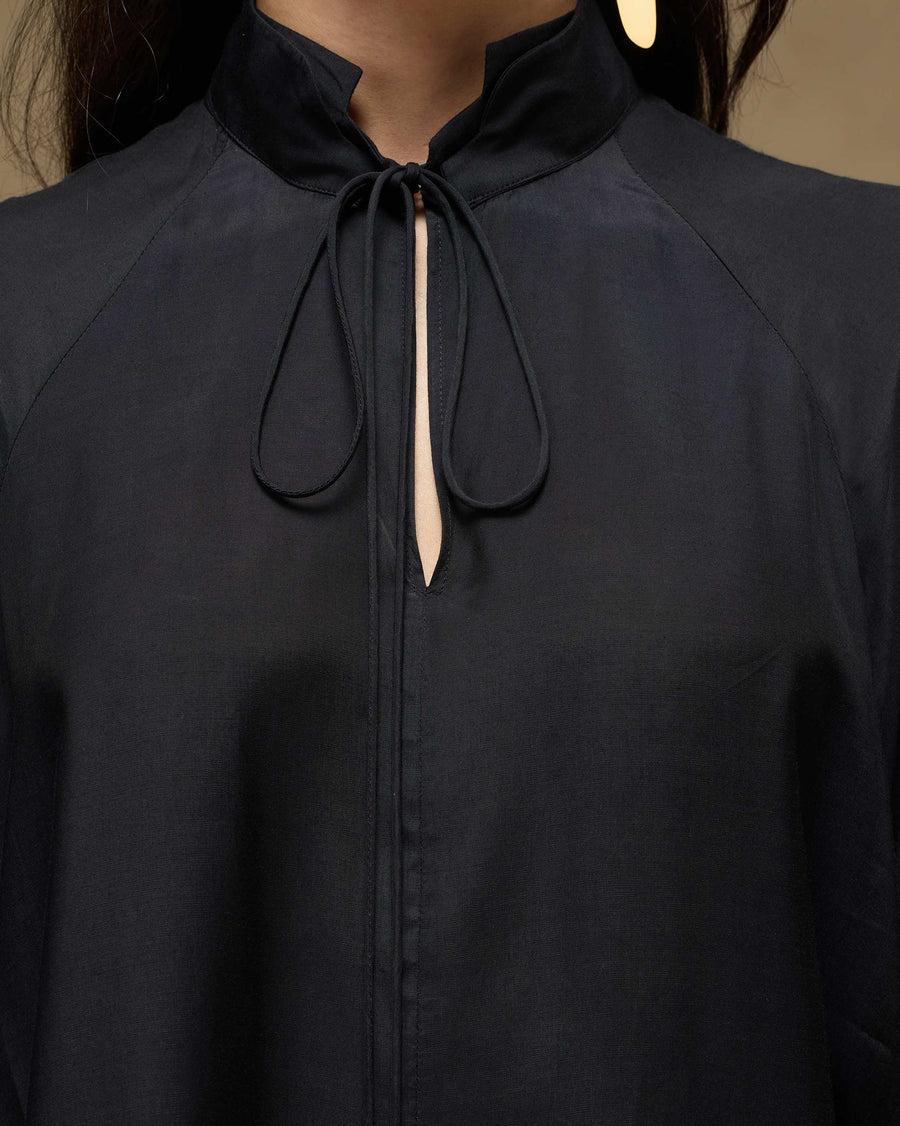 Close-up of the split neckline and slim tie of the Revel Top, showing the smooth drape of the Bemberg.