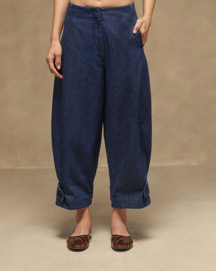The Groove Pants with a hand in the pocket, worn with red flats.