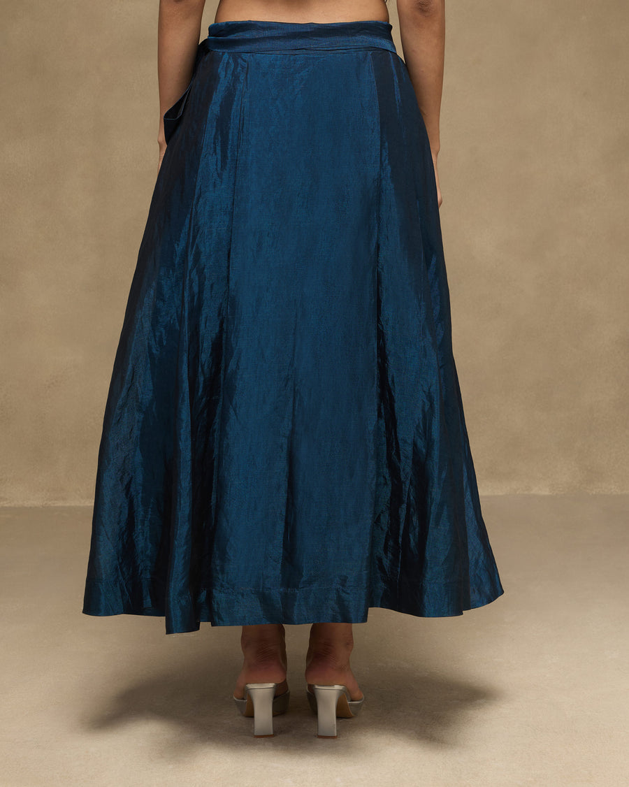 Back view of the Dip Skirt, the sapphire tissue organza shifting from bright to deep blue in its folds.