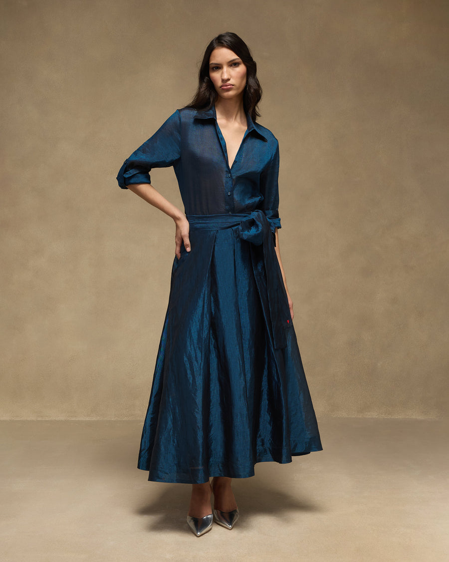 The Dip Skirt with the sapphire Swing Shirt tucked in, sleeves pushed up.