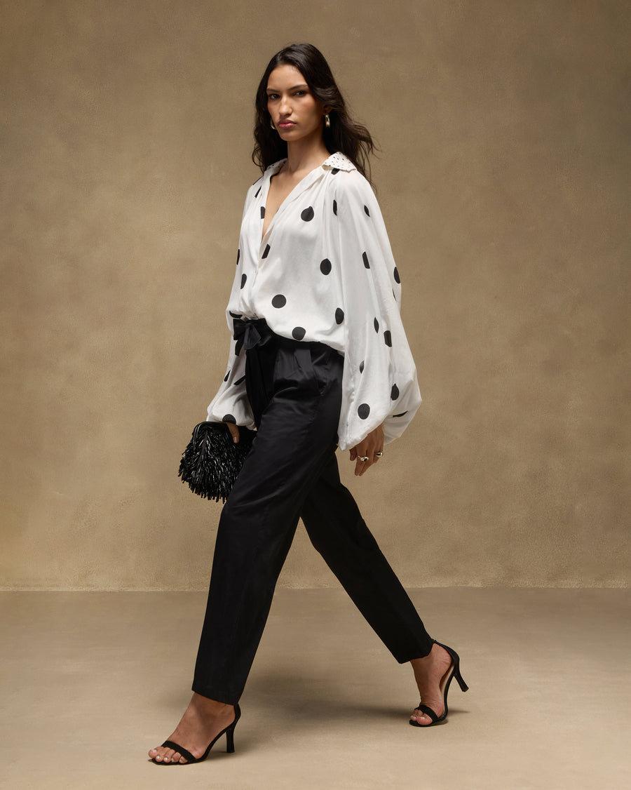 The Cloud Overlay half-tucked into the black Gumdrop Pants, with the Starry Night Clutch.