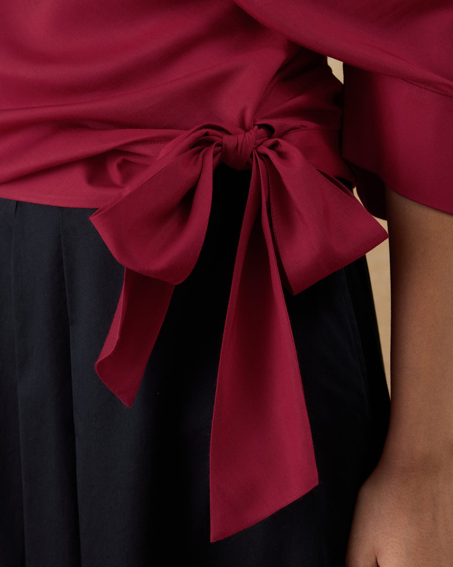 Close-up of the long bow tied at the side waist of the Tokyo Off-Shoulder Top.