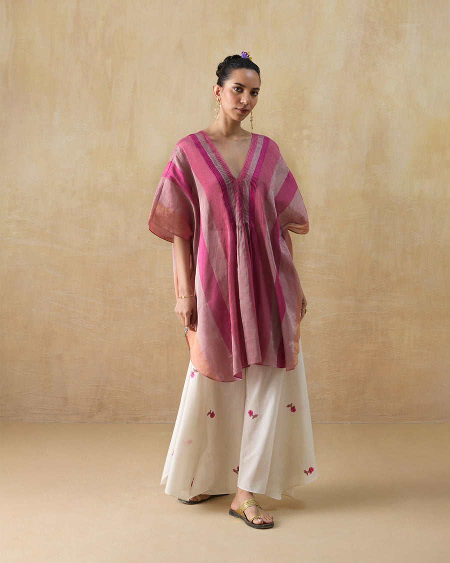 The Jhilmil Kaftan worn over ivory Raahi Pants with flat sandals.