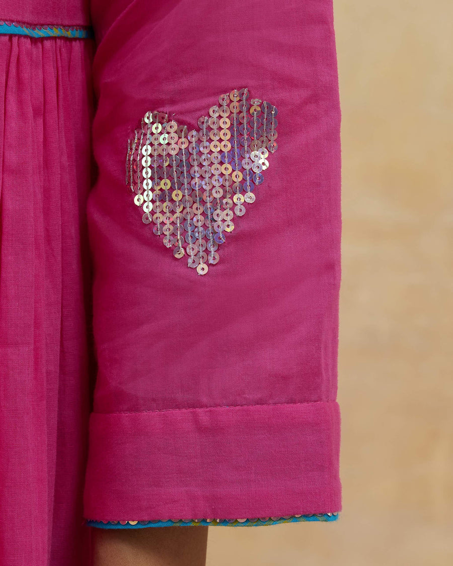 Close-up of the rainbow sequin heart on the sleeve of the Pintuck Kurta.
