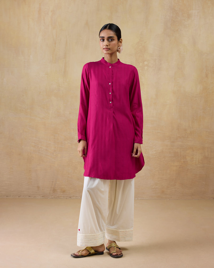 The Numa Pants worn under the berry pink Basic Mid Length Kurta.