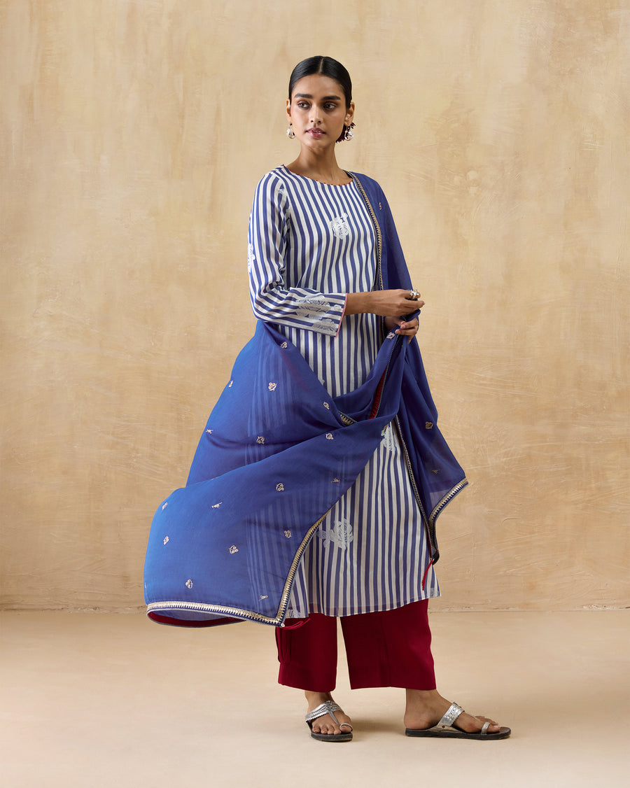 The Boat Neck Kurta worn with red Serene Pants and the blue Leher Dupatta.