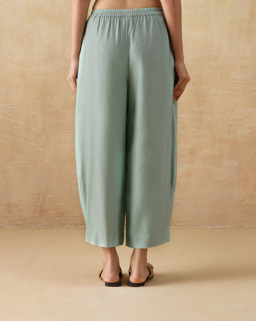 Back view of the Wander Pants in aqua silk blend.