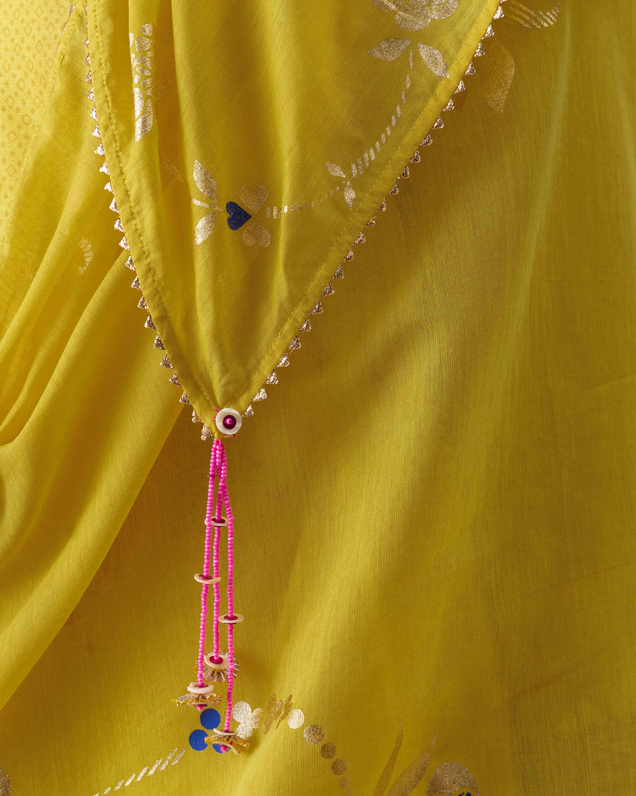 Close-up of a corner of the Gale Dupatta: triangle gota edging and a pink bead and sequin tassel.