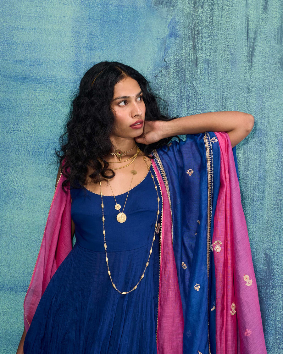 The Leher Dupatta worn over the Kochi Kurta against a blue backdrop, its pink reverse showing.