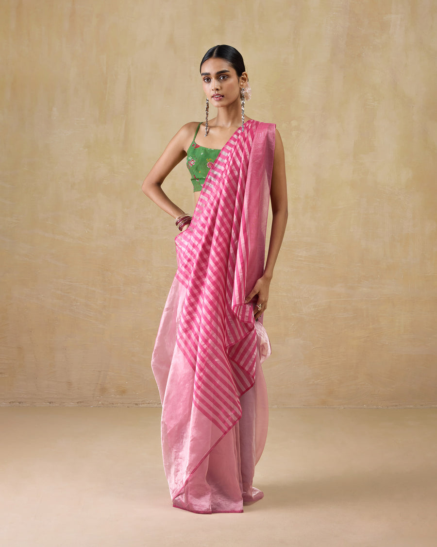 The Blush Sari, a pink metallic tissue sari with a pink and silver striped pallu, worn with a green blouse.