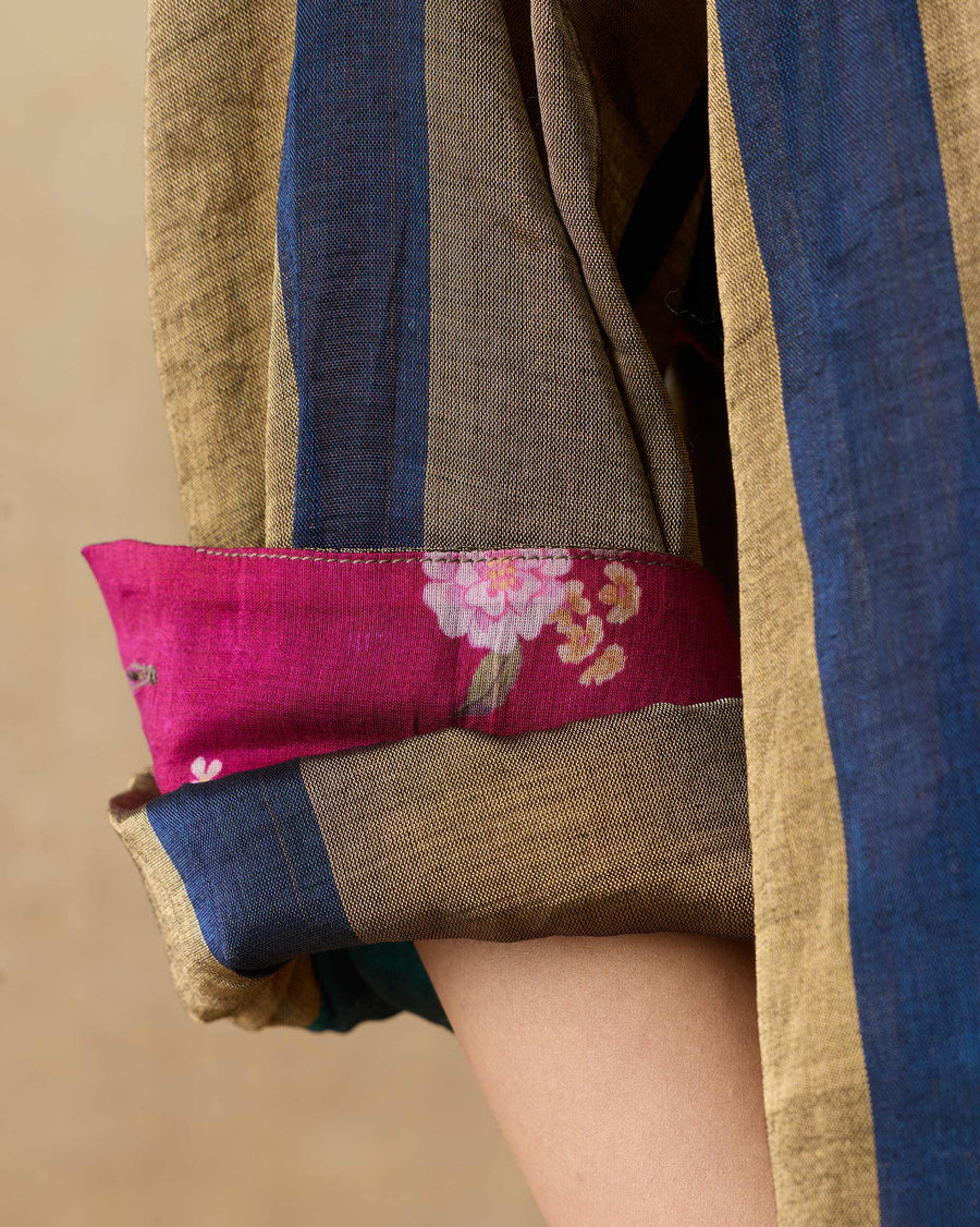 Close-up of the rolled cuff of the Firefly Shirt, showing stripes cut on the bias and a pink printed lining.