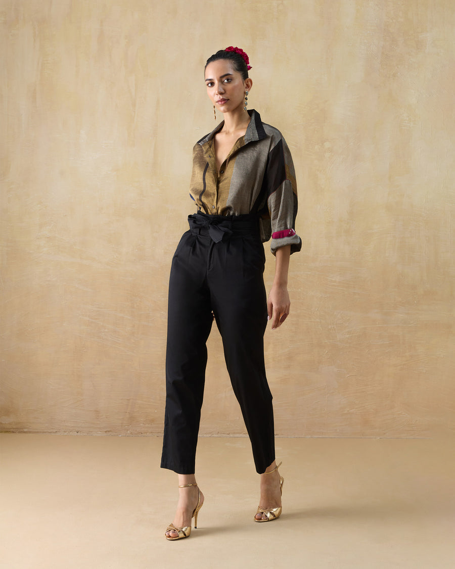 The Firefly Shirt tucked into black Gumdrop Pants with gold heels.