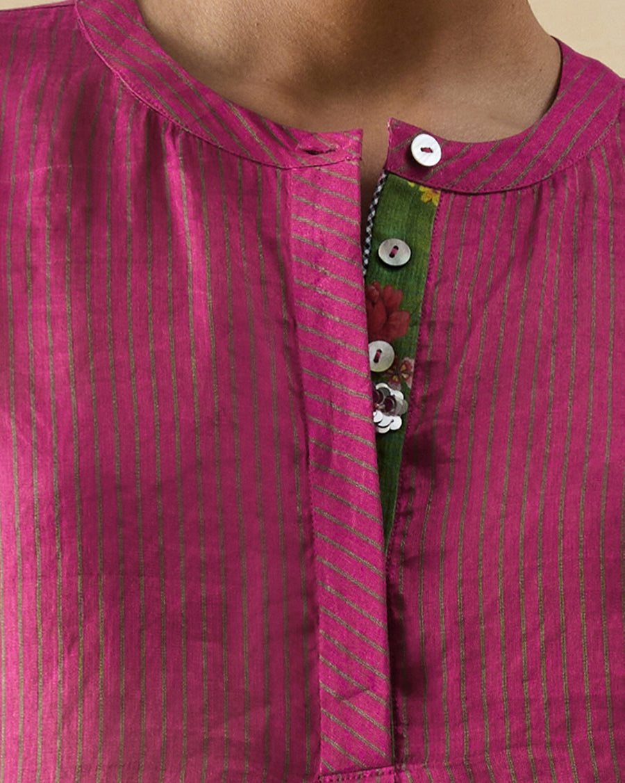 Close-up of the placket of the Lazy Sunday Tunic, with a silver sequin flower peeking out between the buttons.