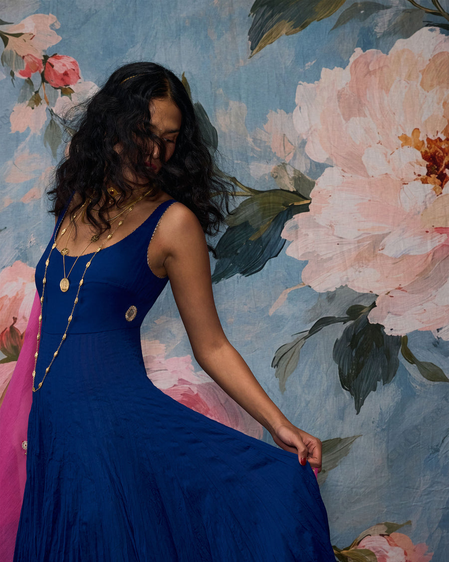The Kochi Kurta, its ghera held out mid-turn against a floral backdrop.