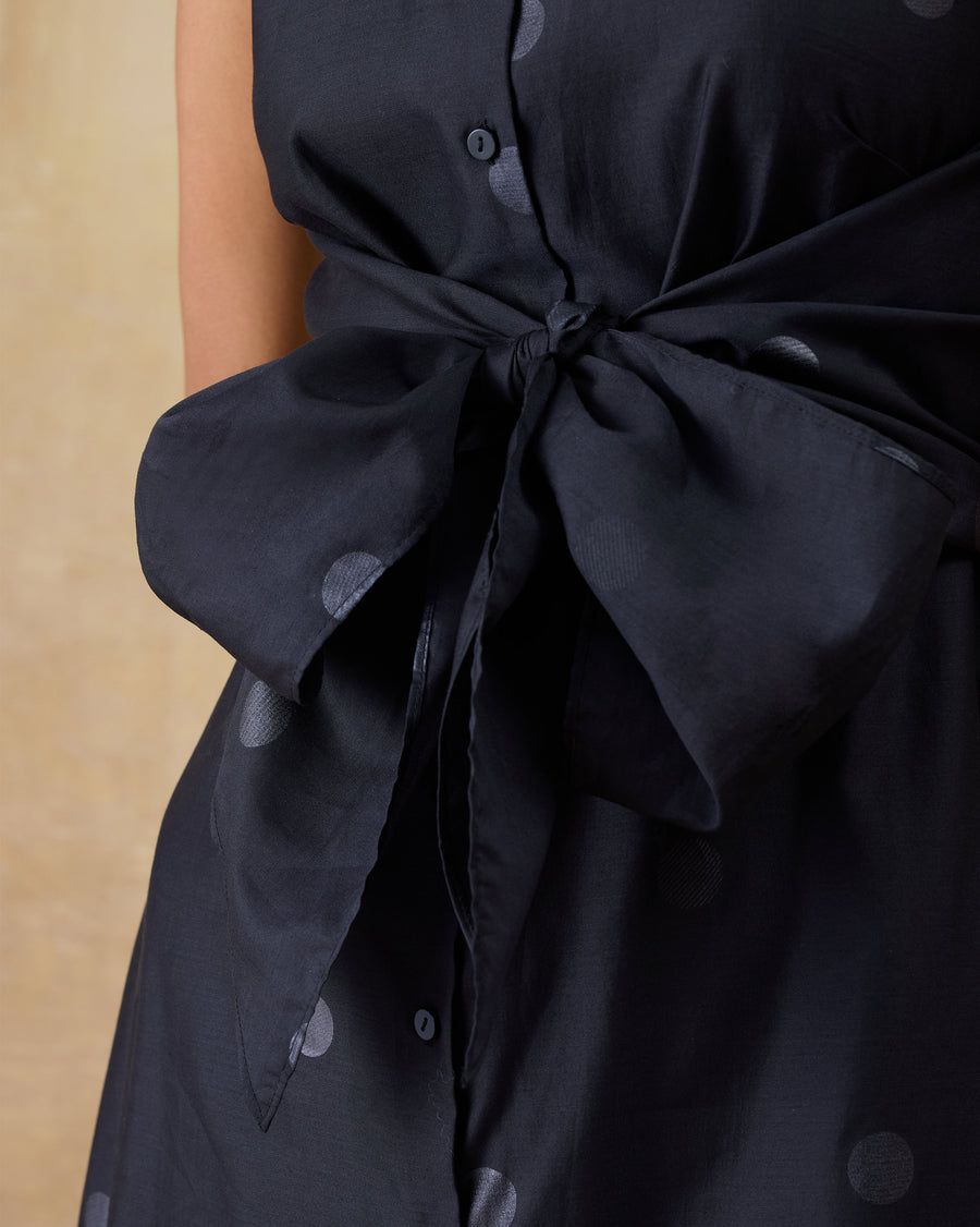 Close-up of the large bow tied at the waist of the Sonnet Dress.