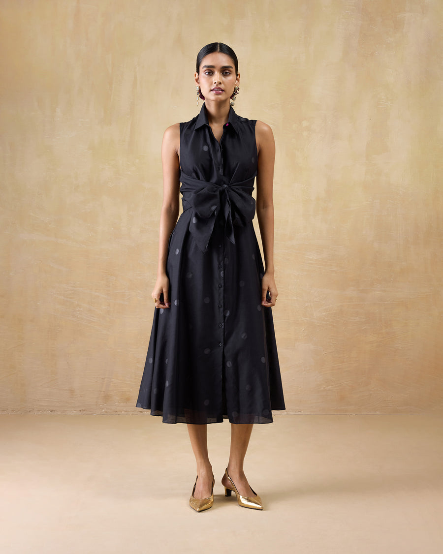 The Sonnet Dress worn with gold heels, the bow tied at the front.