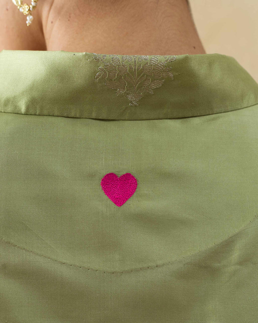 Close-up of the small pink heart embroidered at the centre back of the Boxy Shirt.