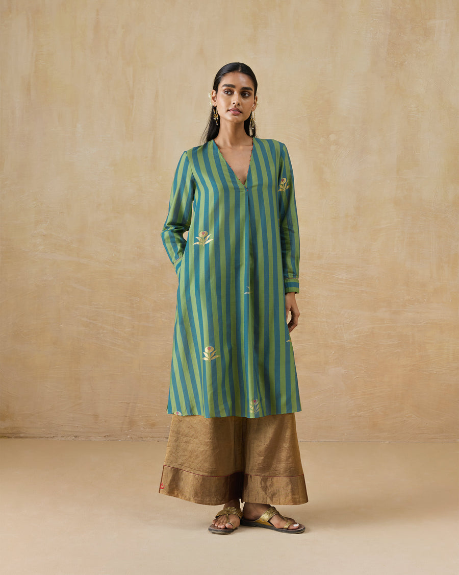 The Front Pleated Kurta, a green and blue striped cotton silk kurta with a V-neck and gold foil buttas, worn over gold trousers.