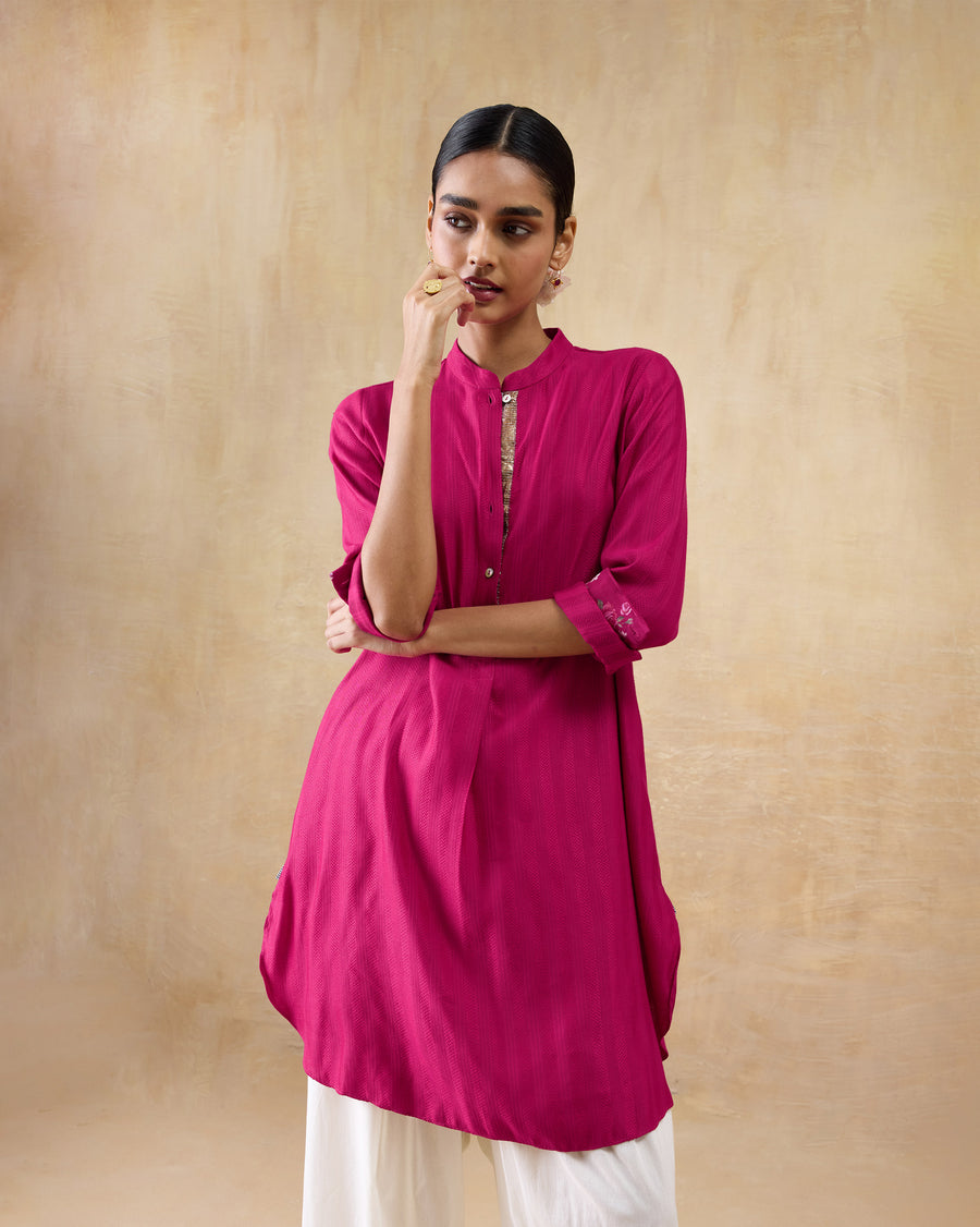 The Basic Mid Length Kurta with its cuffs rolled, the hem curving at the side.