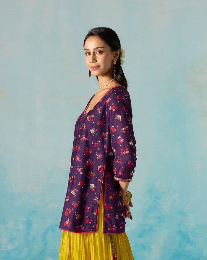 Side view of a purple Sehra kurti with a floral print, worn by a person.