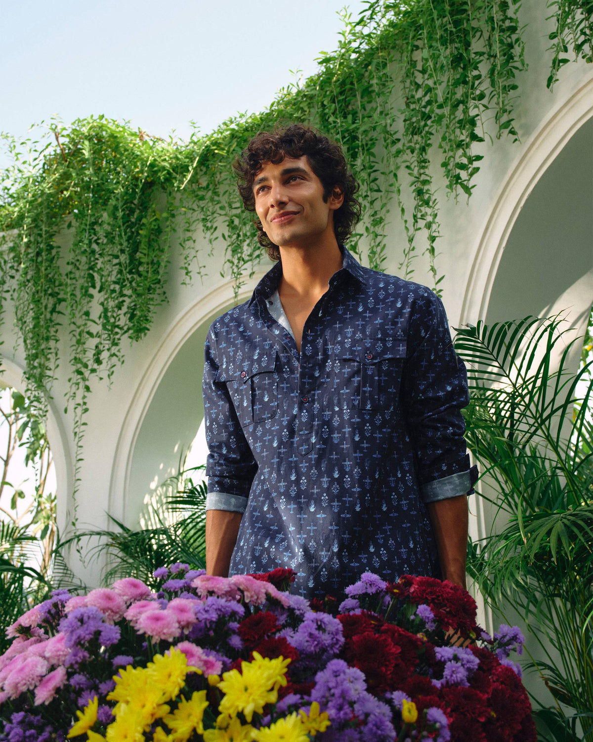 Person wearing a dark blue Hawai Sa Kurta with rolled sleeves.