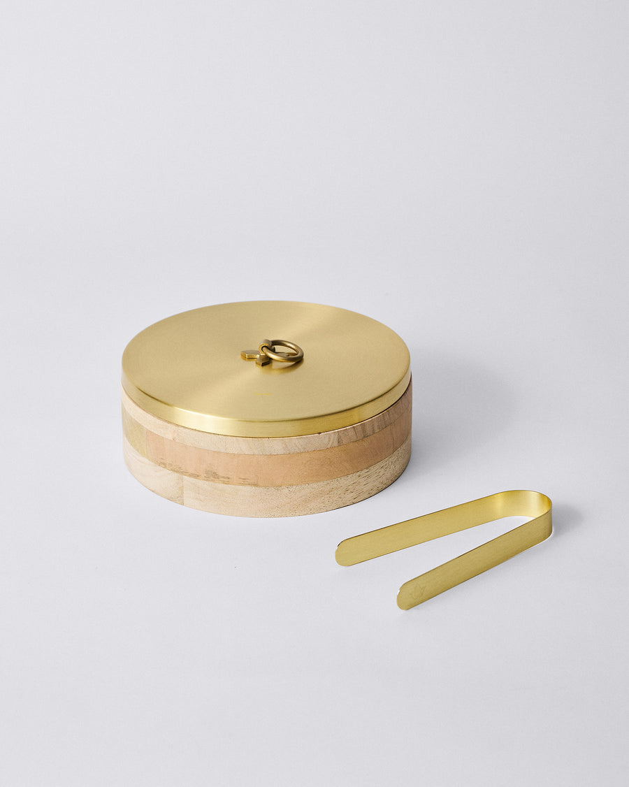 The Roti Box with its brass tongs laid beside it.