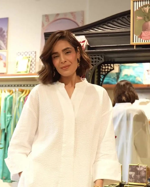 Roohi Marjara in the white seersucker Cirrus Shirt and pyjamas, with gold Rishi earrings