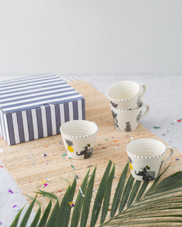 Mugs on a woven mat with confetti