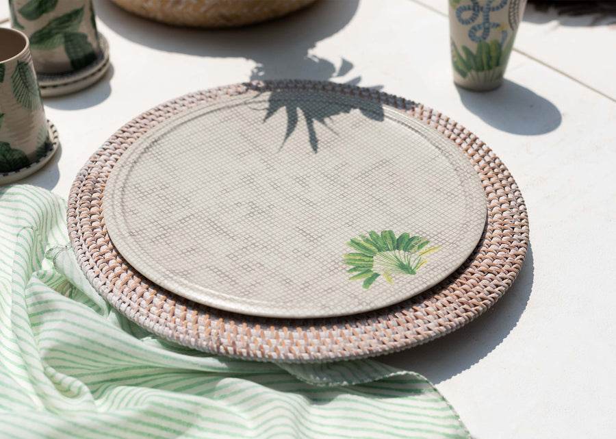 The Madagascar dinner plate on a rattan charger in an outdoor setting