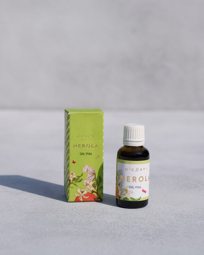 NEROLA fragrance vial standing beside its green box.