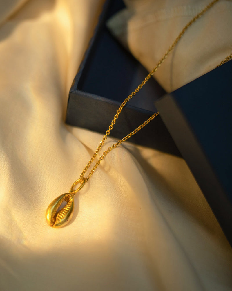Cowri shell charm