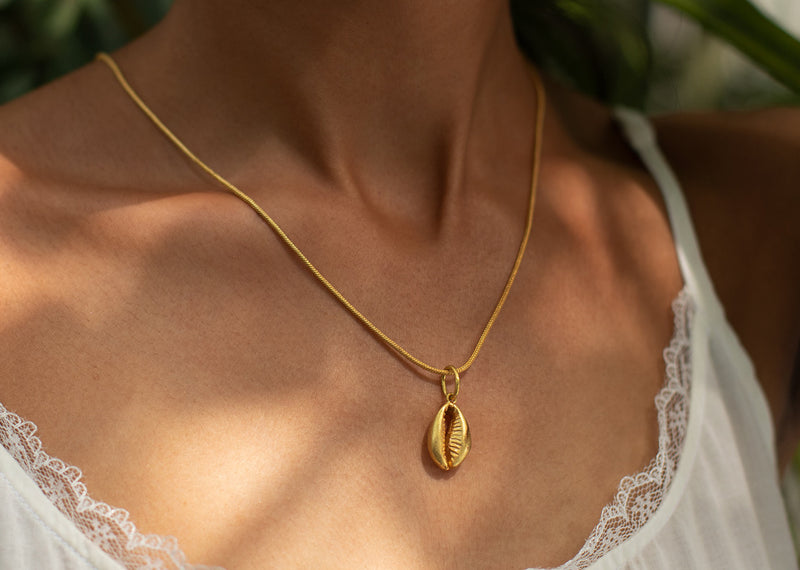 Cowri shell charm